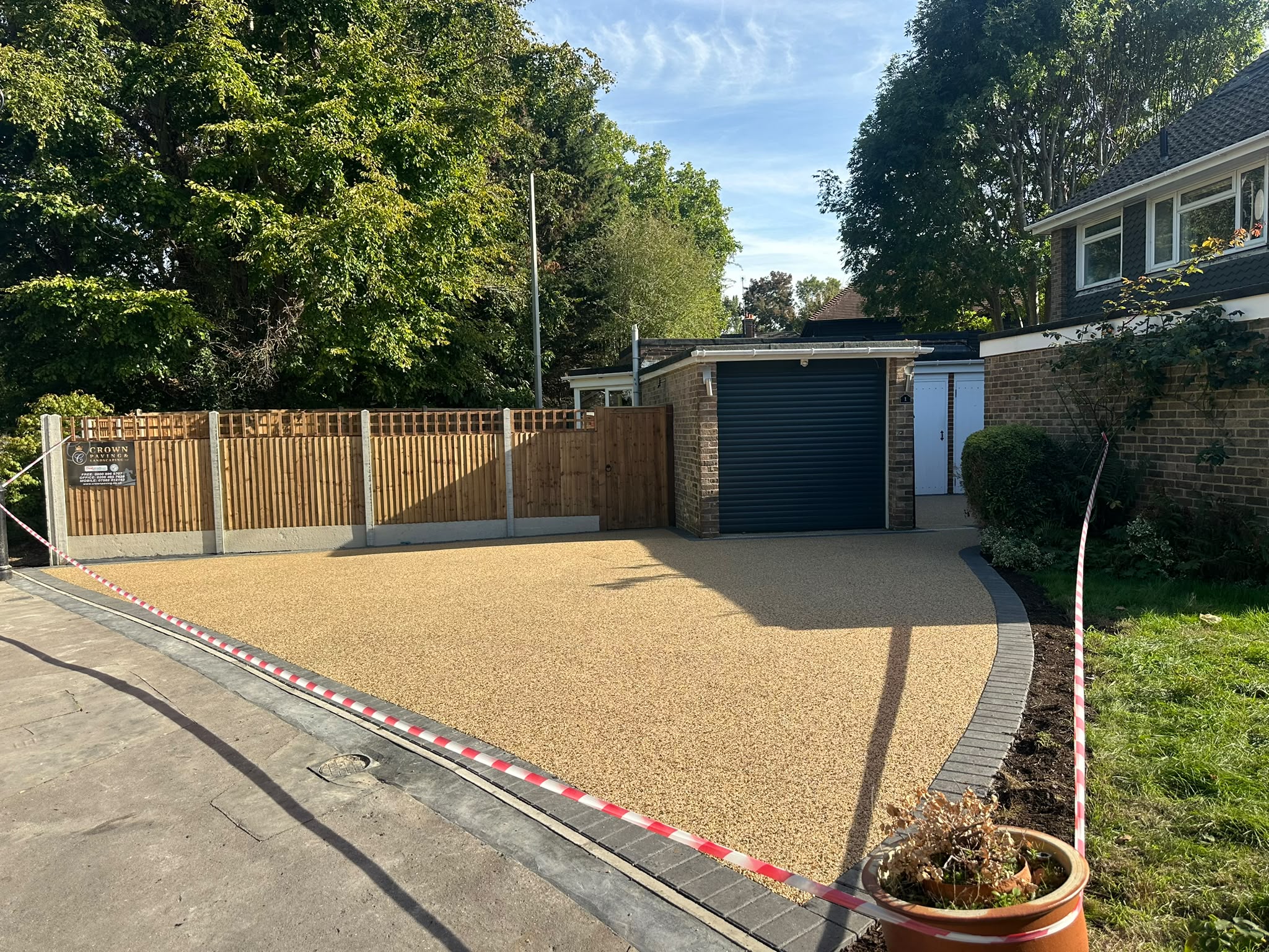 Wide view of a completed resin bound driveway with new fencing and garage access in Selsdon