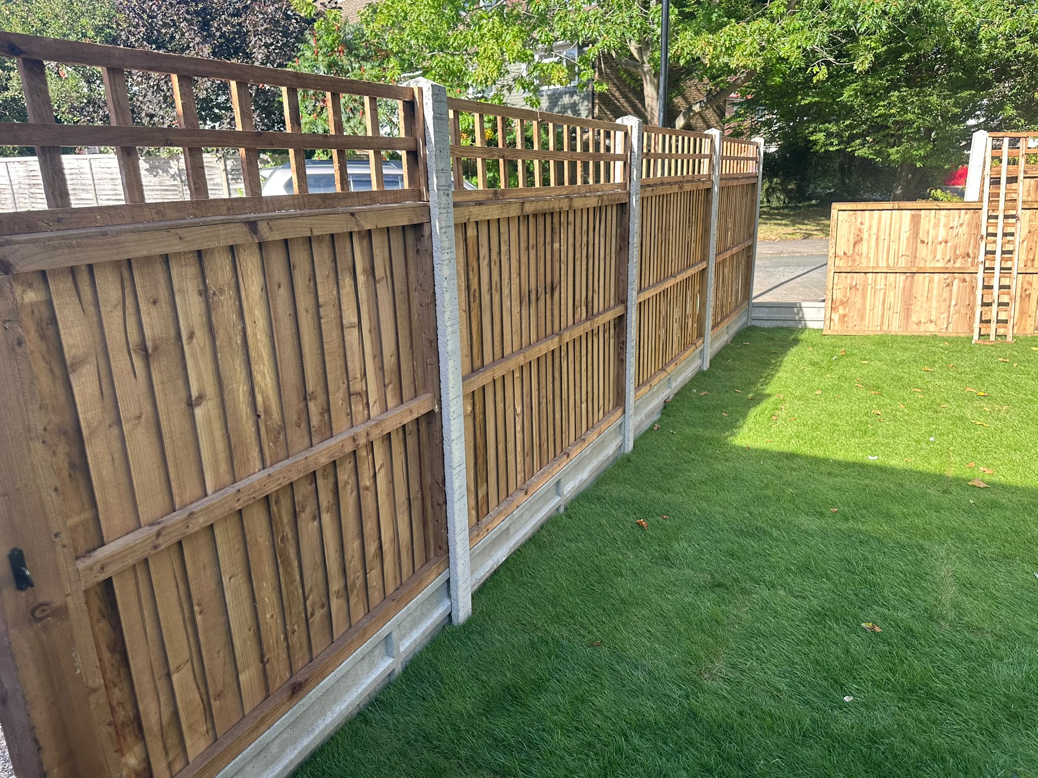 New timber garden fencing with concrete posts alongside freshly laid turf in Selsdon